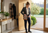 Woman using an Ouchlove crossbody bag during a workday.