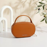 Ouchlove Harriet Vegan Leather Crossbody Bag being used on a crowded NYC subway platform