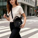 Woman using a crossbody bag with a glasses compartment for daily commuting.